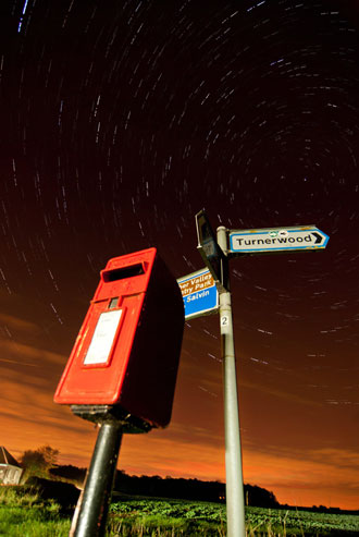 post box star trail illuminated with car headlights