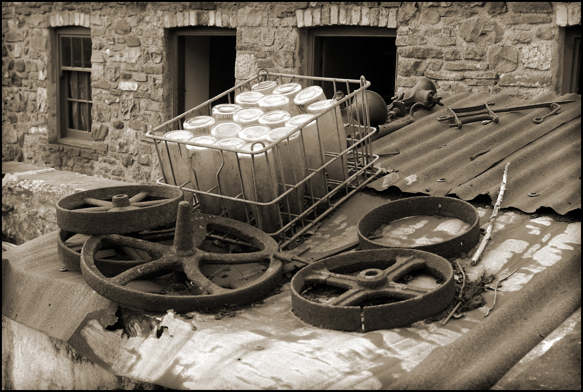 Crate and iron wheels on a cold tin roof