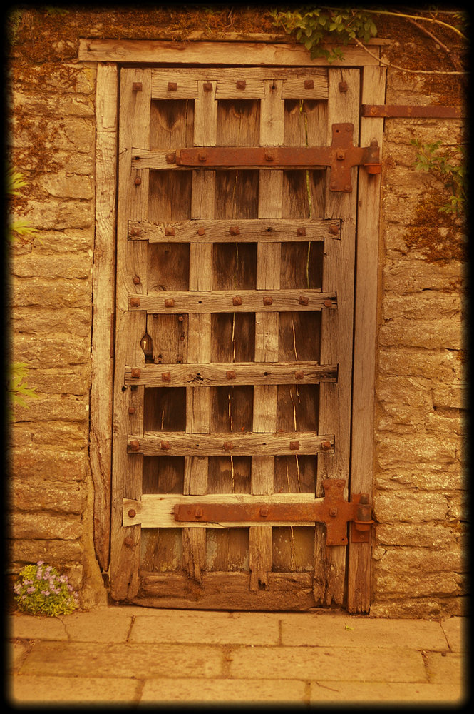 Old doorway  with rusty hinges.