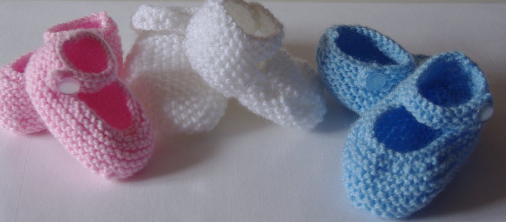 Blue,Pink and white babies shoes.