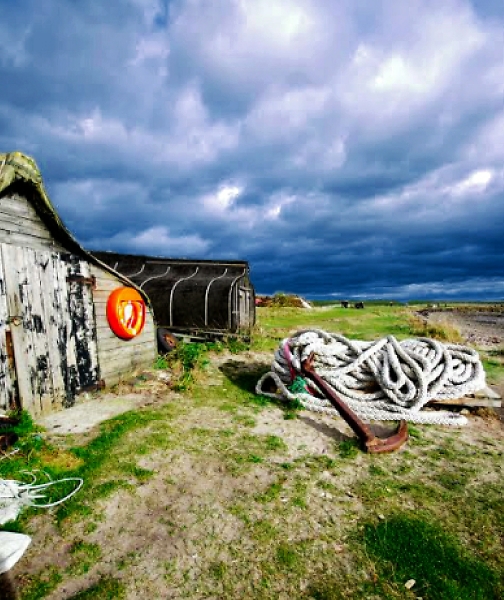 Upturned boats and anchor,