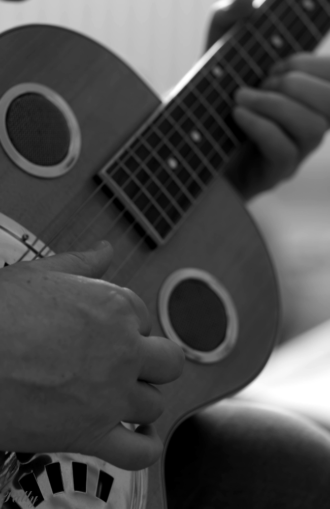 Black and white, hands playing guitar