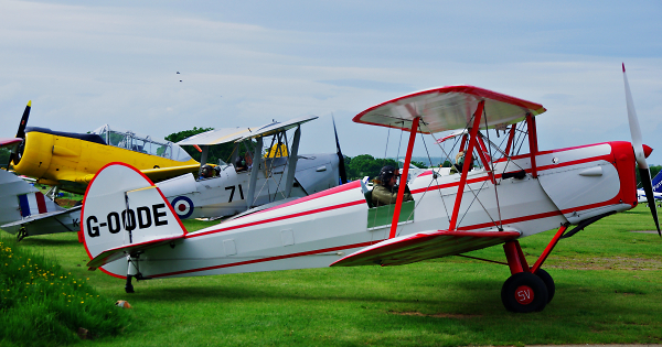 Stampe and Tiger Moth in the background and distant Harvard..