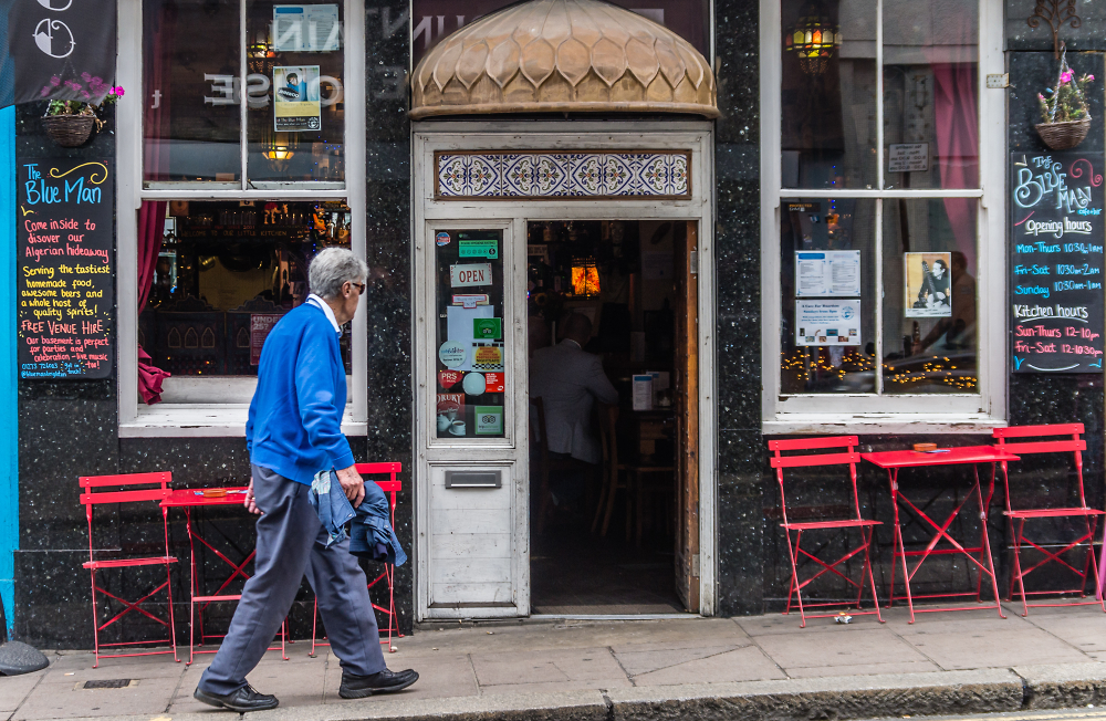 Man in Blue Walks past The Blue Man.