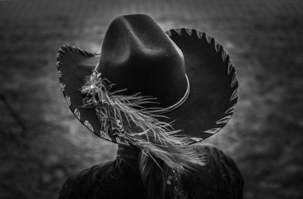 The feathered hat worn by a cowgirl