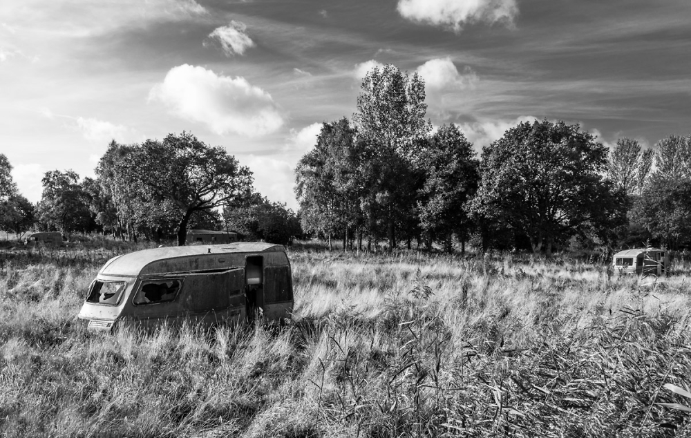 Abandoned caravans in a field