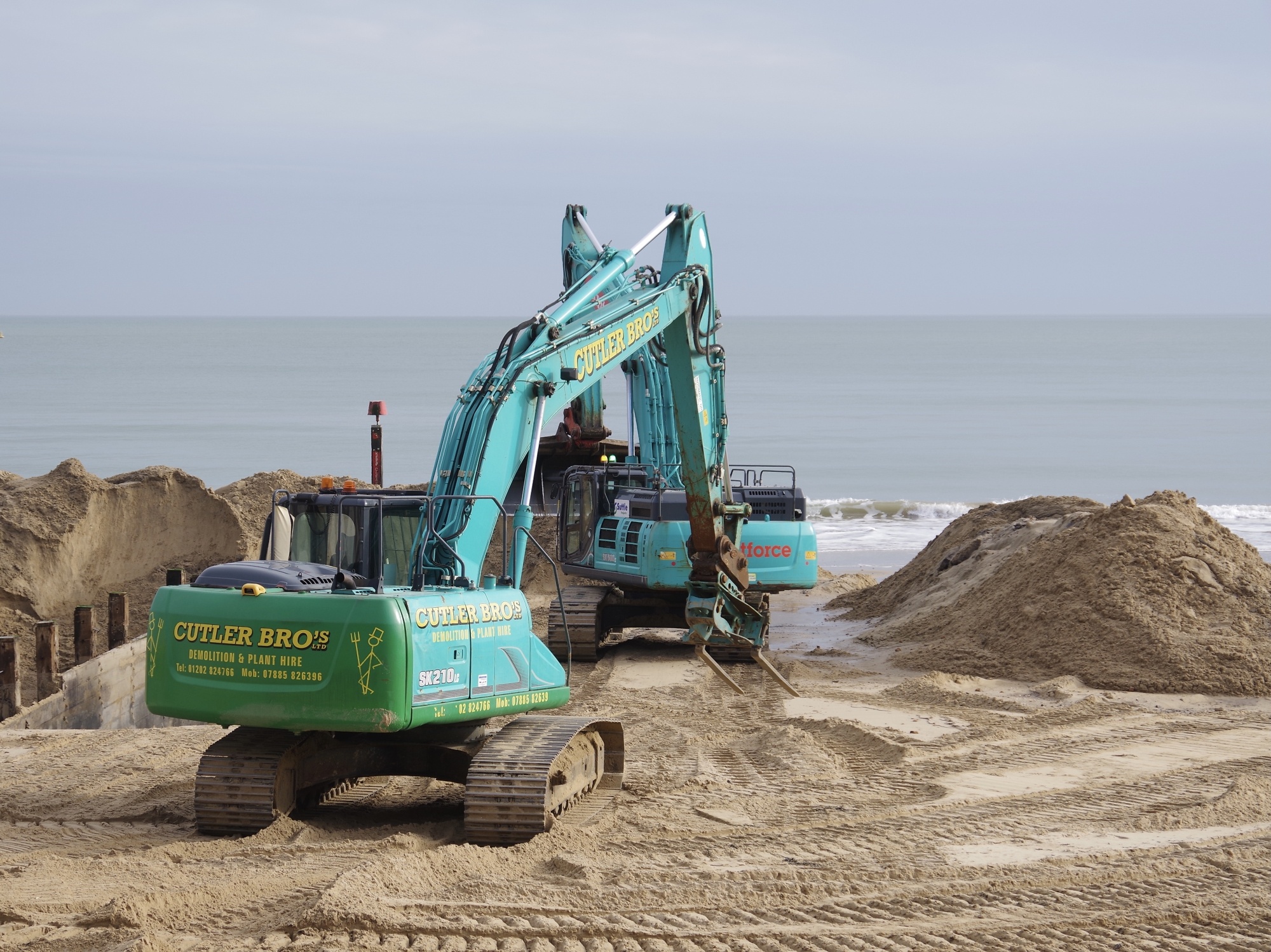 Replacing grounds on Bournemouth beach.