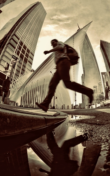 Man leaping over a puddle
