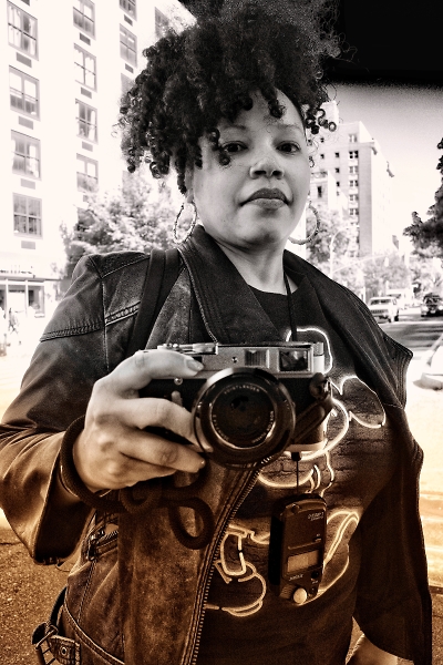 Woman photographer poses for her own photo