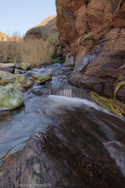 Stream flowing down to the beach.