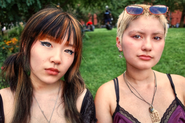 Two girls on a park bench